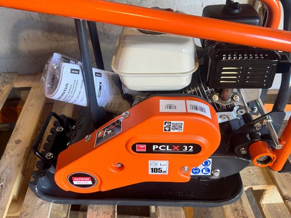 Orange PCLX 32 machine on a wooden pallet.