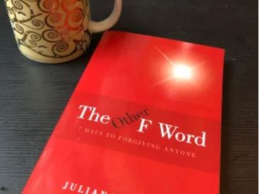 red book with coffee mug next to it