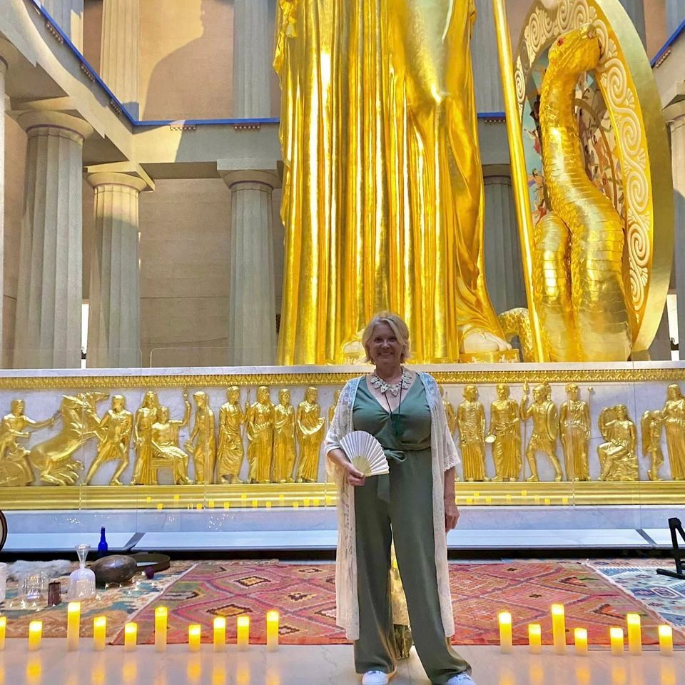 woman standing with candles behind