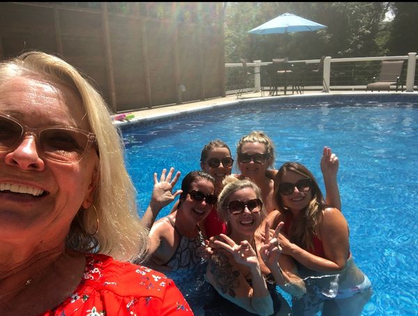 a group of women in a swimming pool smiling