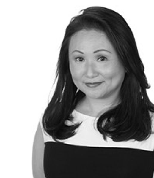 Professional black and white portrait of a smiling woman.