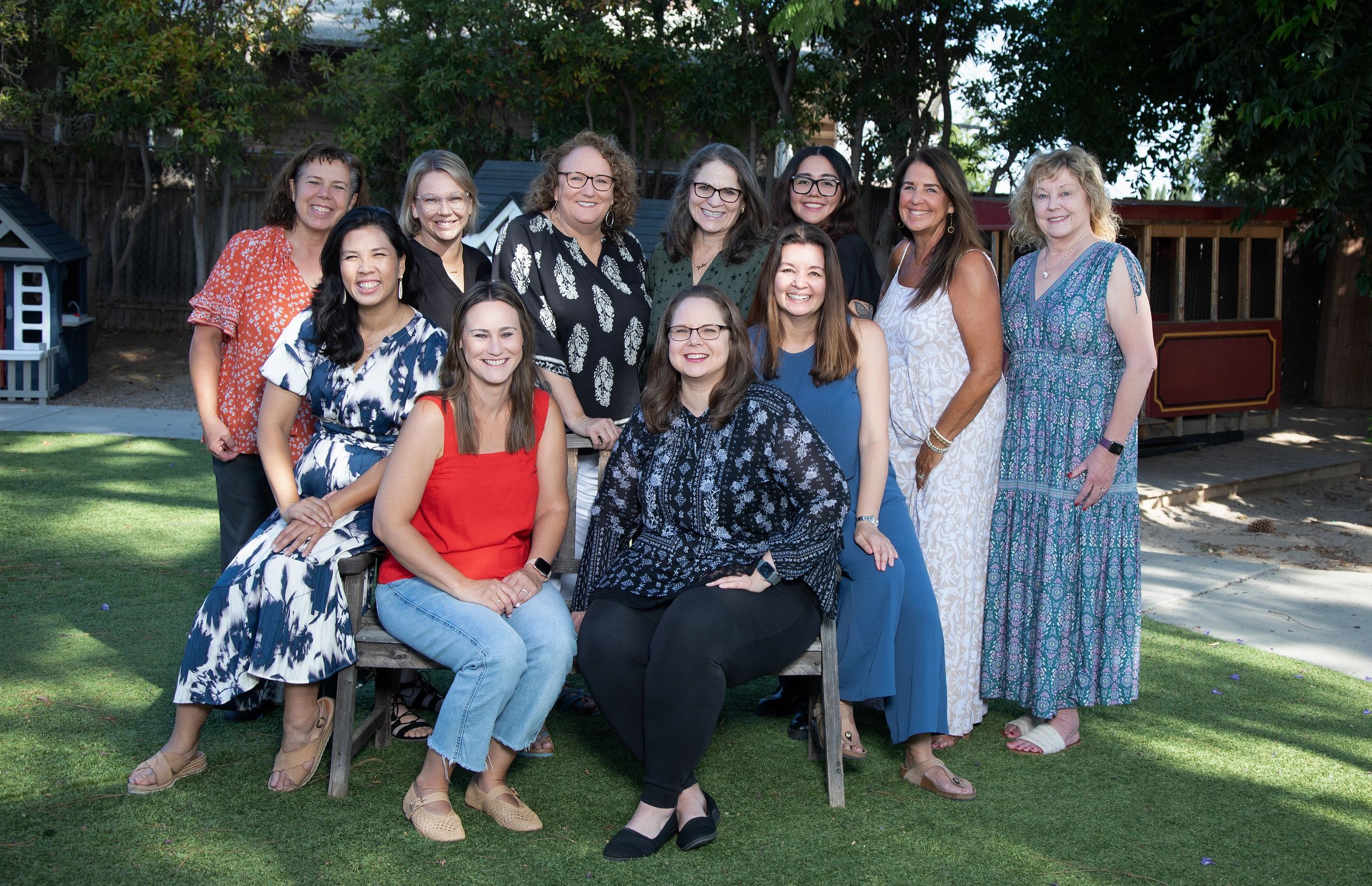 Group photo of smiling women outdoors.