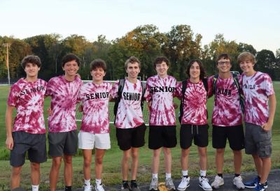 Group of seniors in matching shirts outdoors.