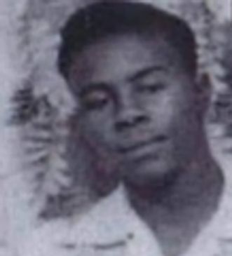 Black and white portrait of a young man with a calm expression.