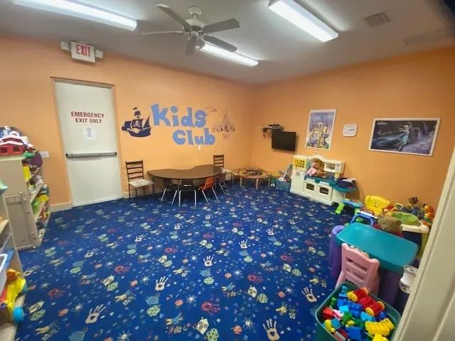 Bright kids' playroom with colorful carpet and toys.