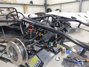 Spyders Inc 718-rsk space frame-chassis double wishbone front suspension being assembled