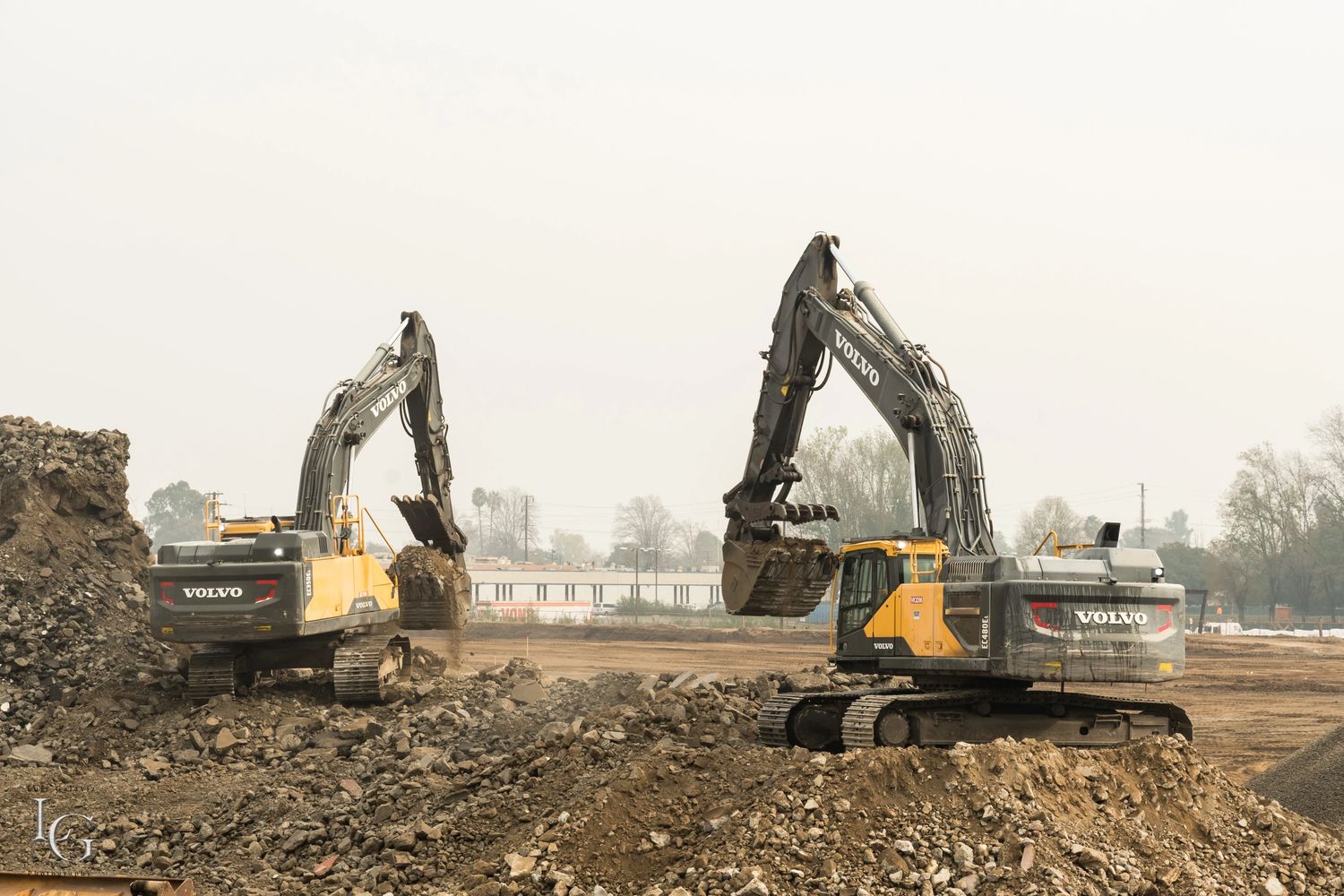 Demolition site clearing, concrete recycling, excavator team work, Volvo Excavator