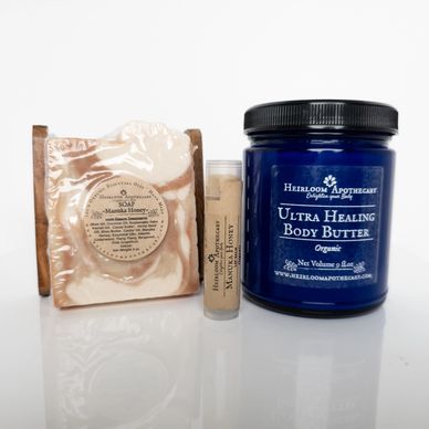 Natural skincare products including soap, lip balm, and body butter.