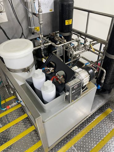 Industrial water filtration system with pipes and filtration components.