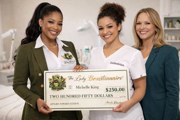 Three women smiling and holding a $250 tuition check for Michelle King.