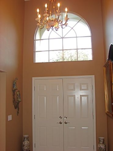 A white door with yellow chandelier 