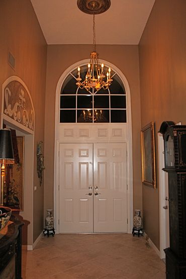 An arch shape white color door for entrance 