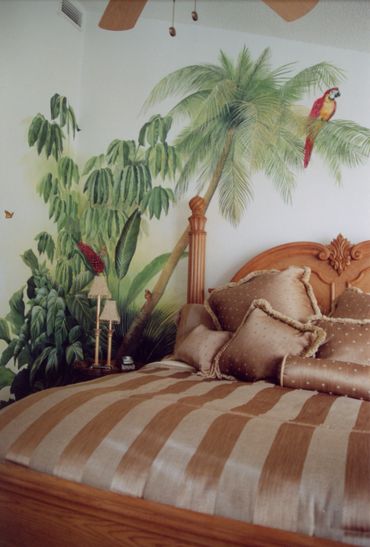 Artwork of trees and birds on the wall of a bedroom