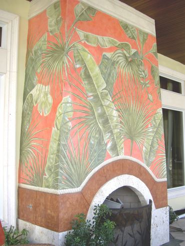 A lovely wall painting of some trees at the firplace