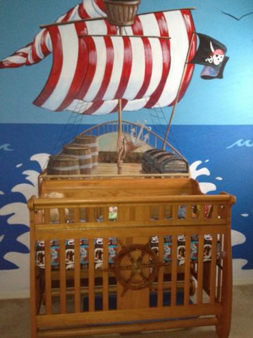 A wall painting of a pirate ship sailing in the sea