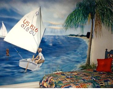 Artwork of a boy sailing on the wall of a bedroom