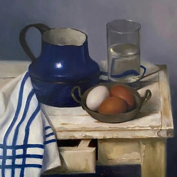 Still life with pitcher, glass, eggs, and towel on white table.