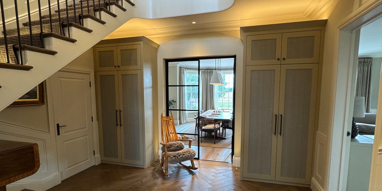 Bespoke fitted entrance hall cupboards with shaker doors and integrated lighting