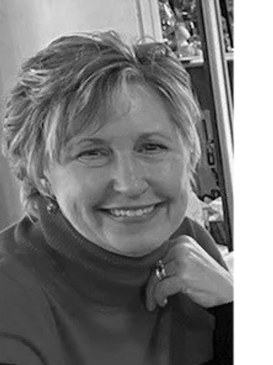 Smiling woman in a red turtleneck sweater.