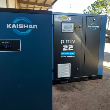 Industrial Kaishan air compressor and air dryer unit in a workshop.