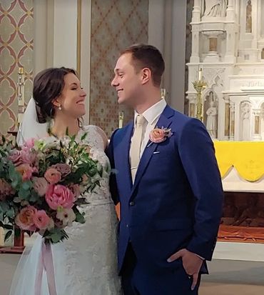 In this image the groom and bride are looking lovingly at each other with big smiles.
