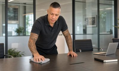 Man Maid Orlando owner providing professional commercial office cleaning at a conference table in Or