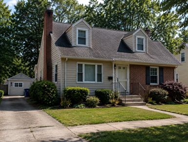 Single-family house with a front lawn and driveway.