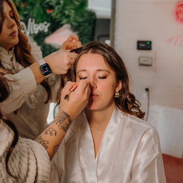 Woman getting makeup and hair done.