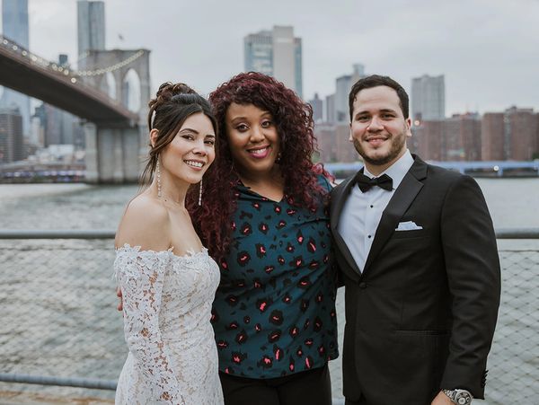 Wedding Officiant Sharron Paul with happy wedding couple next to Brooklyn Bridge