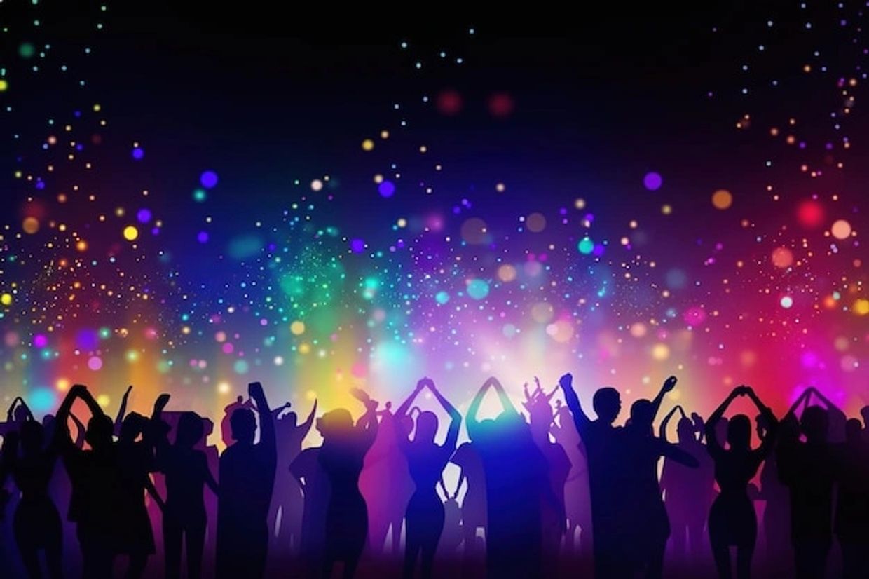 Silhouettes of people dancing with colorful lights in the background.