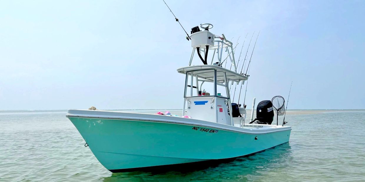 Blue fishing boat on calm water.