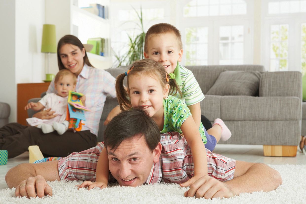 Families spending Time  together on Carpet