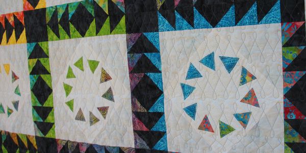 Sunburst Society by Lizard Creek Quilting. Fabric by Island Batik