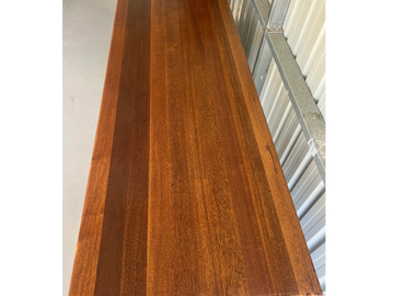 Polished wooden tabletop with rich, warm tones and distinct grain patterns.