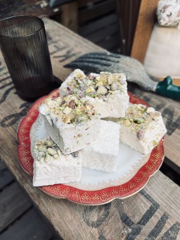 Pistachio topped marshmallows on pretty plate