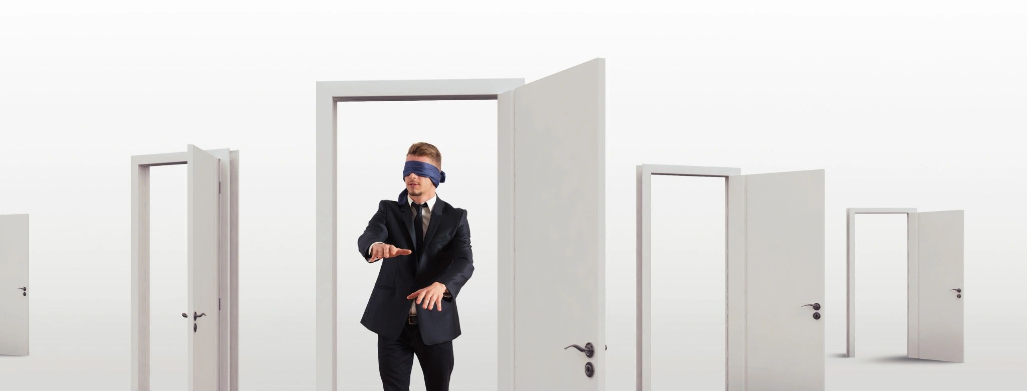 Blindfolded man in suit navigating through multiple open doors.