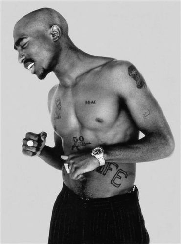 Tupac singing with no shirt on