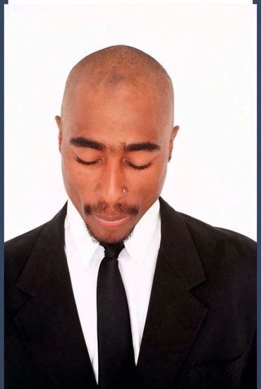 Tupac with a suit and tie on