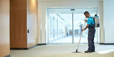 Janitor cleaning a hallway near IRS Taxpayer Assistant Center.