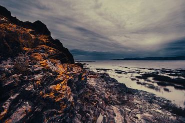 Formation rocheuse avec des dépôts de couleur orange - vue du fleuve et nuages vaporeux