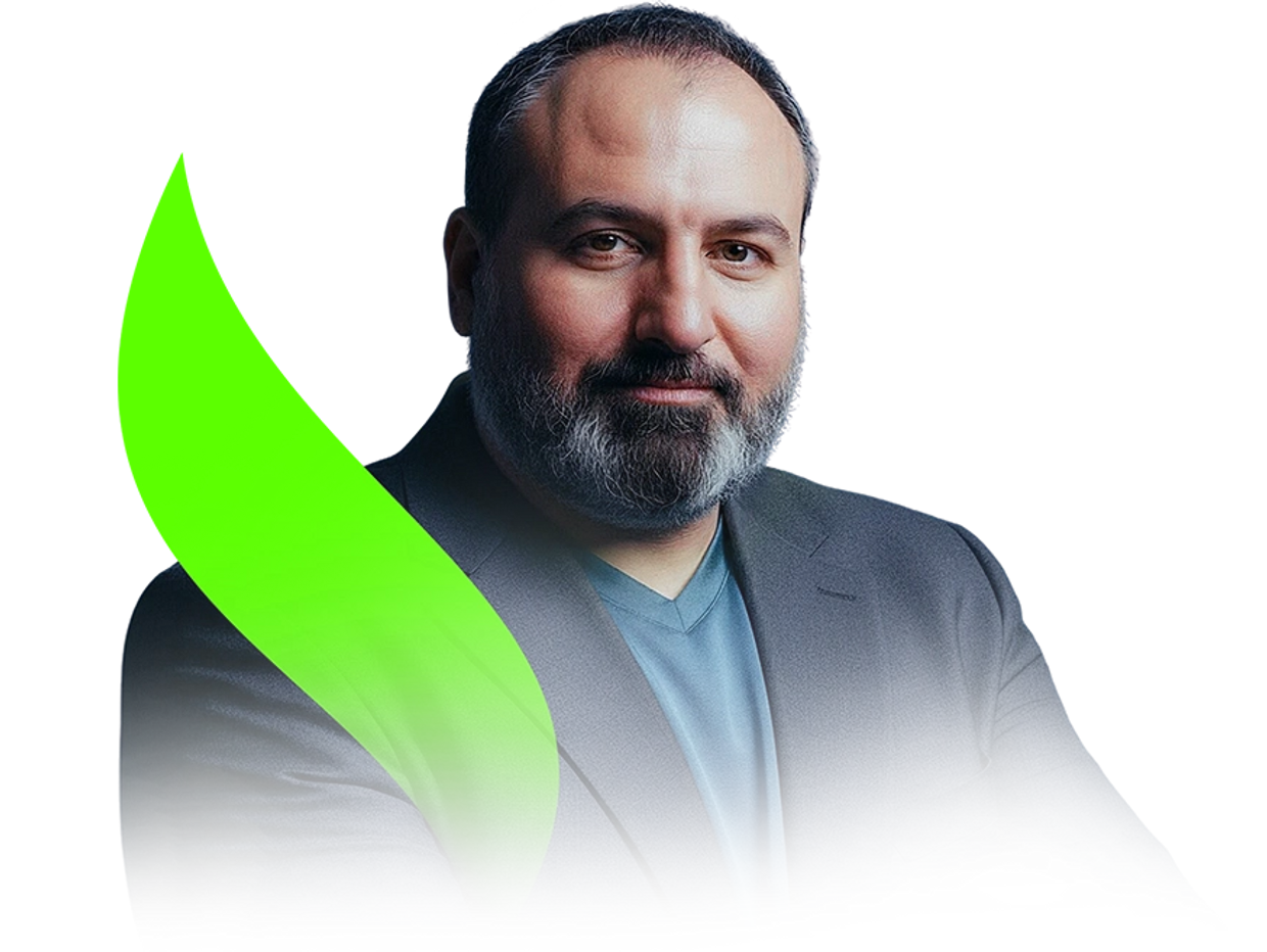 Confident man with a beard wearing a blazer and blue shirt.
