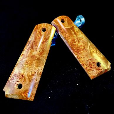 Pair of wooden pistol grips with detailed grain.