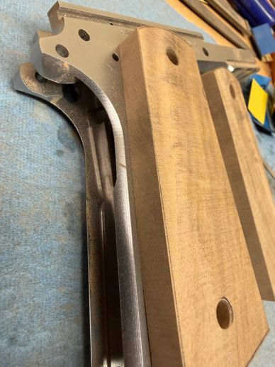Wood and metal parts with drilled holes.