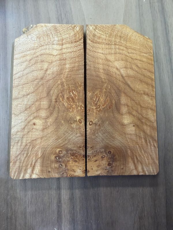 Two pieces of natural wood with symmetrical grain patterns.
