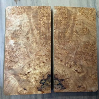 Two rectangular wooden slabs with unique grain patterns.