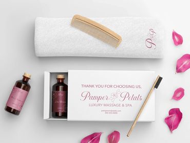Luxury spa set with oils, towel, wooden comb, and rose petals by Kindall Wright - KX Graphic Design.