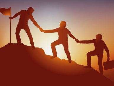 The symbol of teamwork in business with a group helping each other to climb a mountain