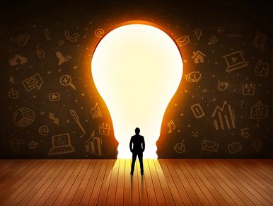 Businessman looks at light bulb in wall concept