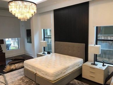 A king size mattress and bed frame in master bedroom after professional mattress cleaning.