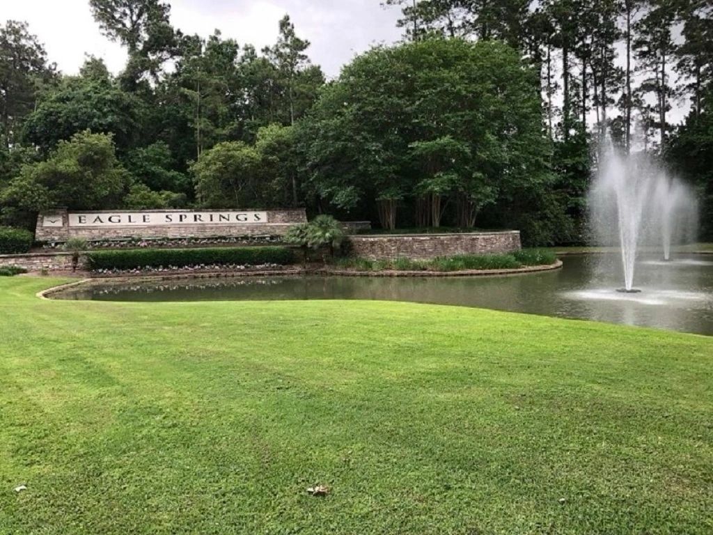 The Eagle Springs subdivision sign with a pong and water fountain in Atascocita, Texas.